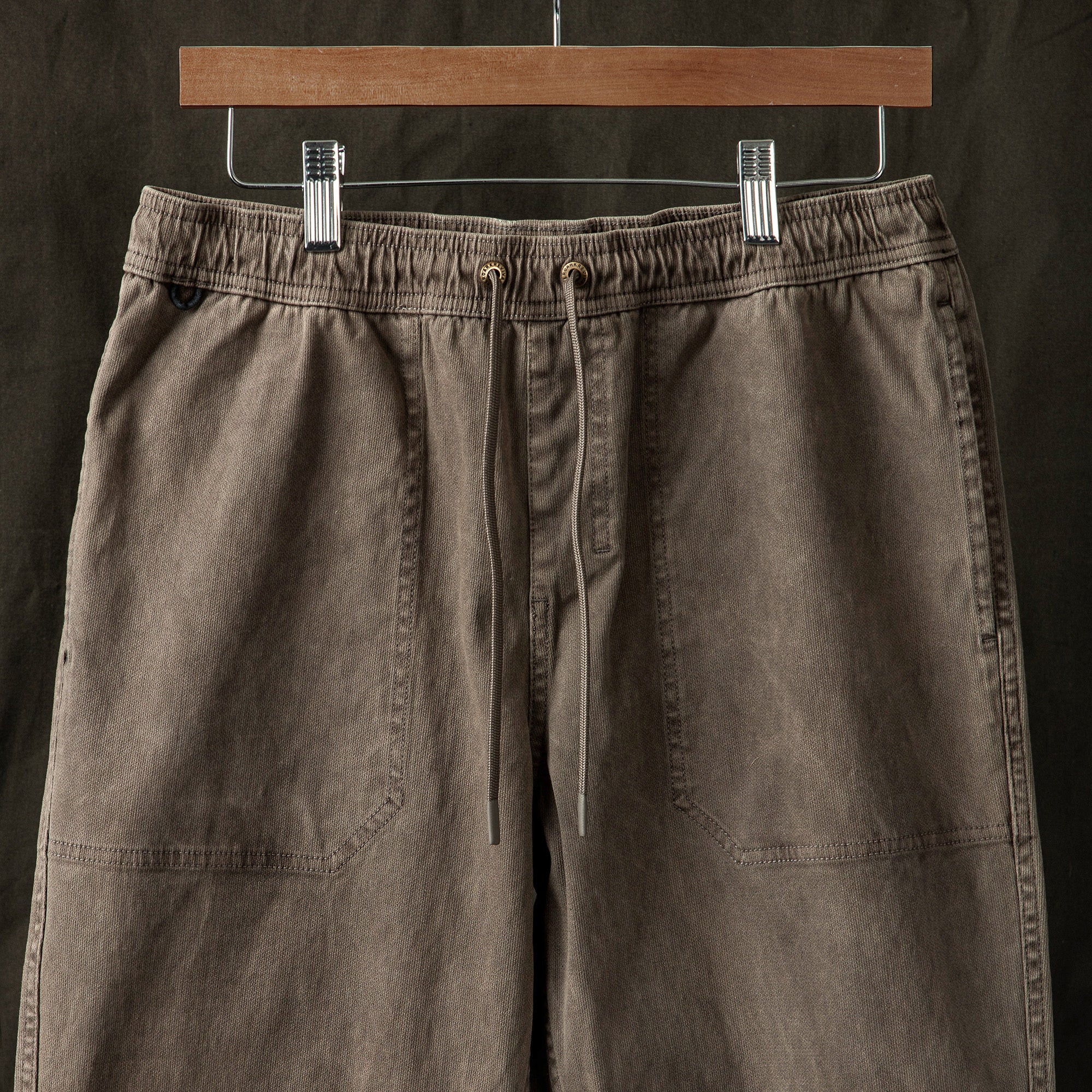 Brown Bermuda shorts featuring denim and linen materials with visible pockets, perfect for adventure and travel by Roark.