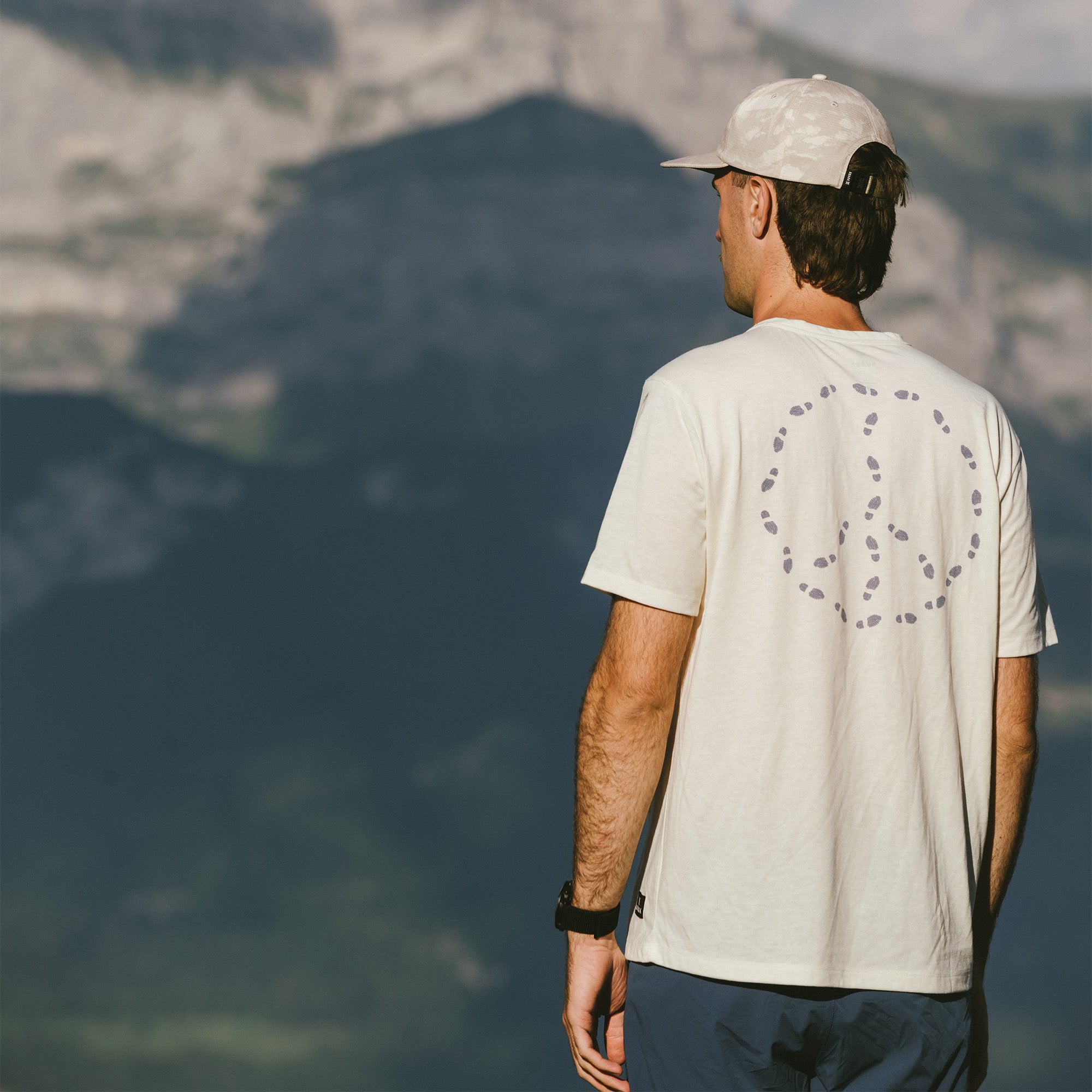 Man wearing a Roark Mathis Active Short Sleeve Tee with a baseball cap, ready for an outdoor adventure