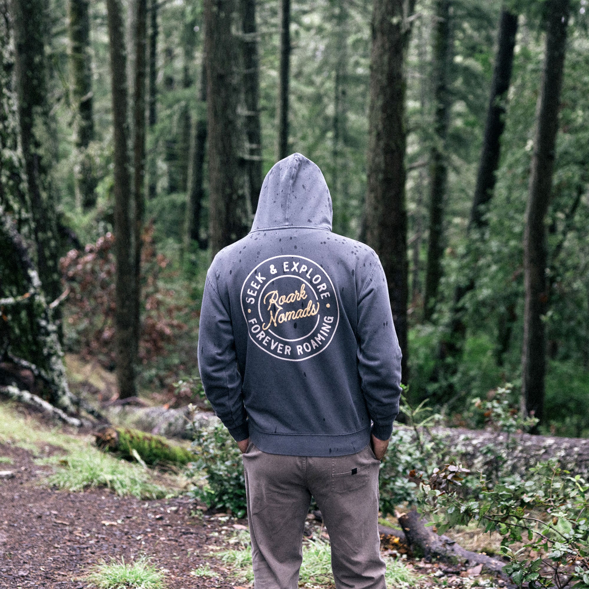 Hoodie with denim jacket overlay showcasing the Nomads Badge design, ideal for outdoor adventures.