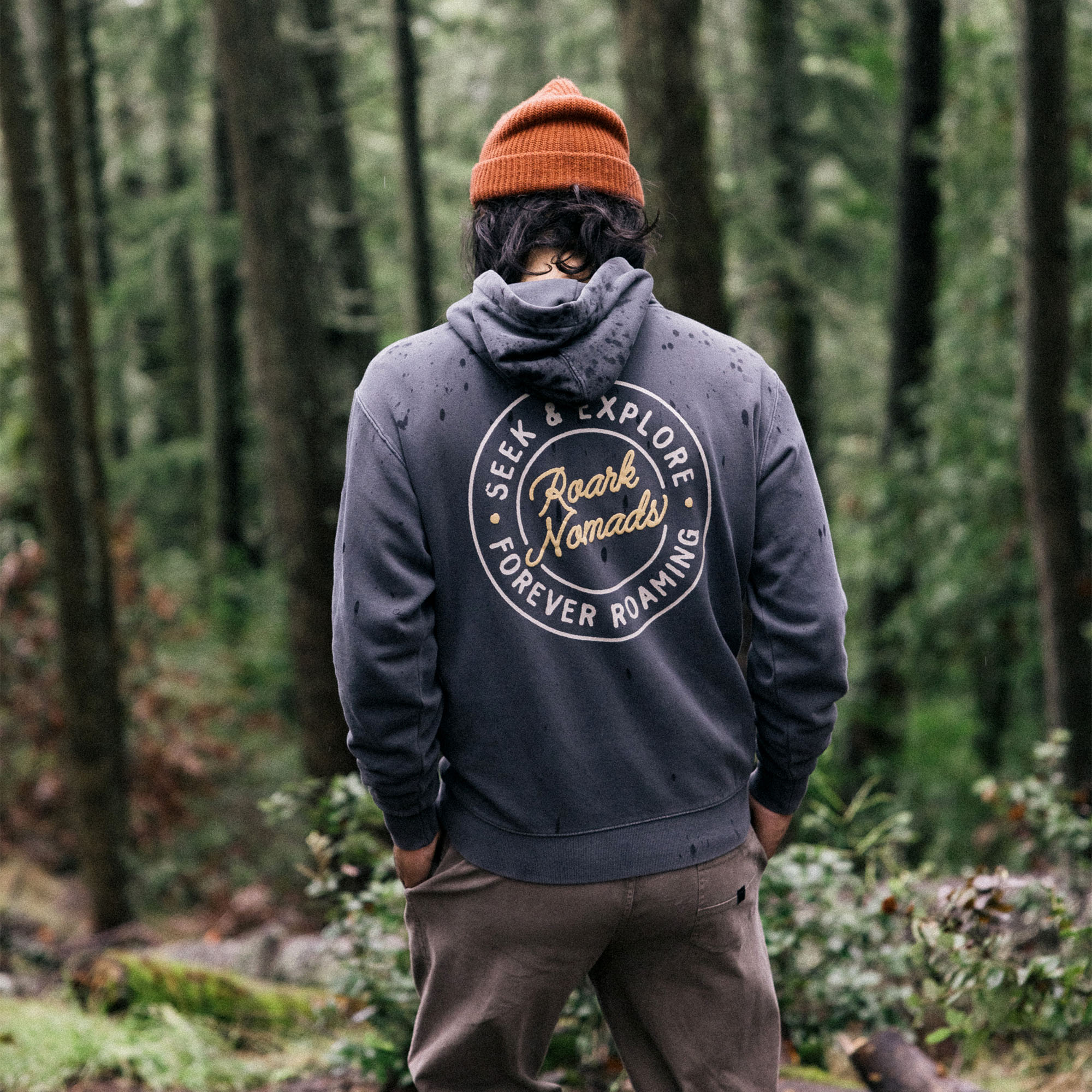 Close-up of the Nomads Badge fleece hoodie with denim jacket featuring prominent Roark logo on the sleeve and hood detail, perfect for outdoor adventures.