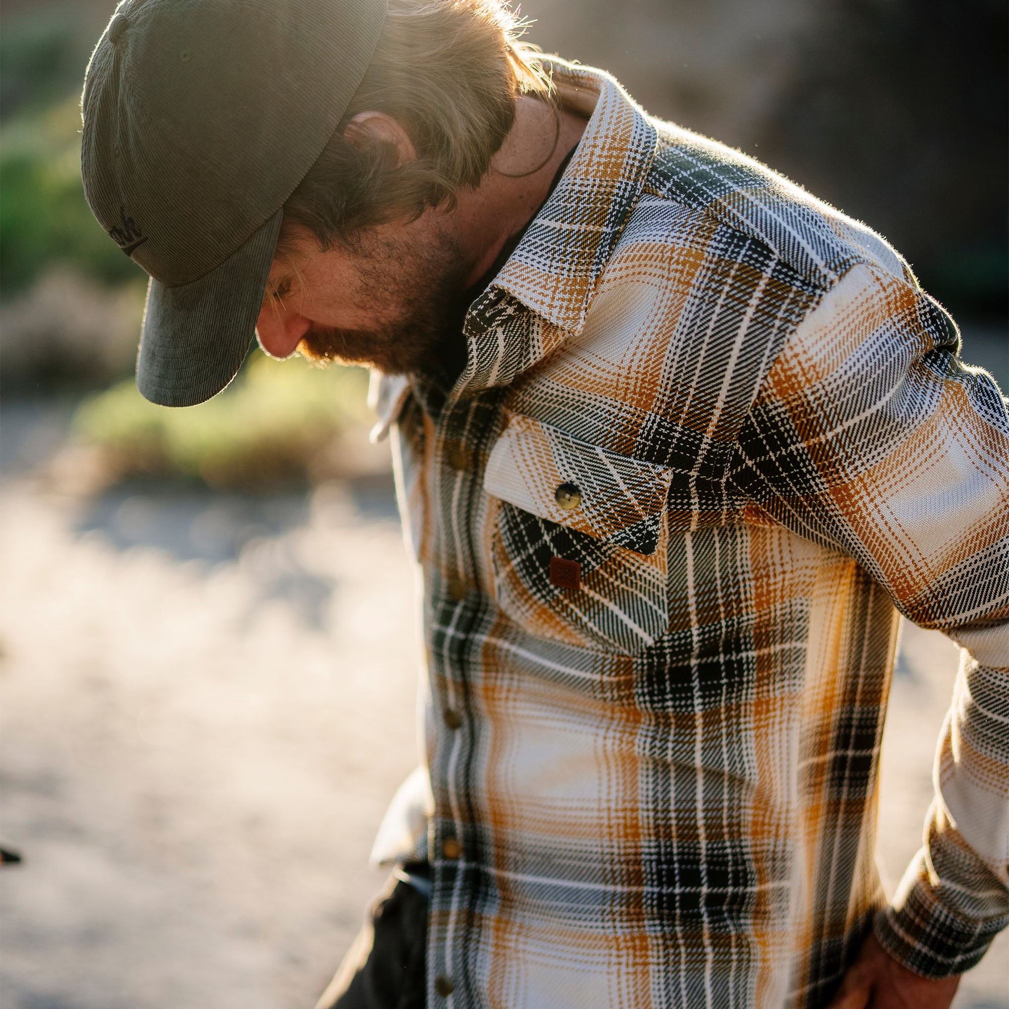 Group of friends in a natural setting wearing Roark's Nordsman Cotton Flannel shirts paired with denim, featuring a classic tartan plaid design.