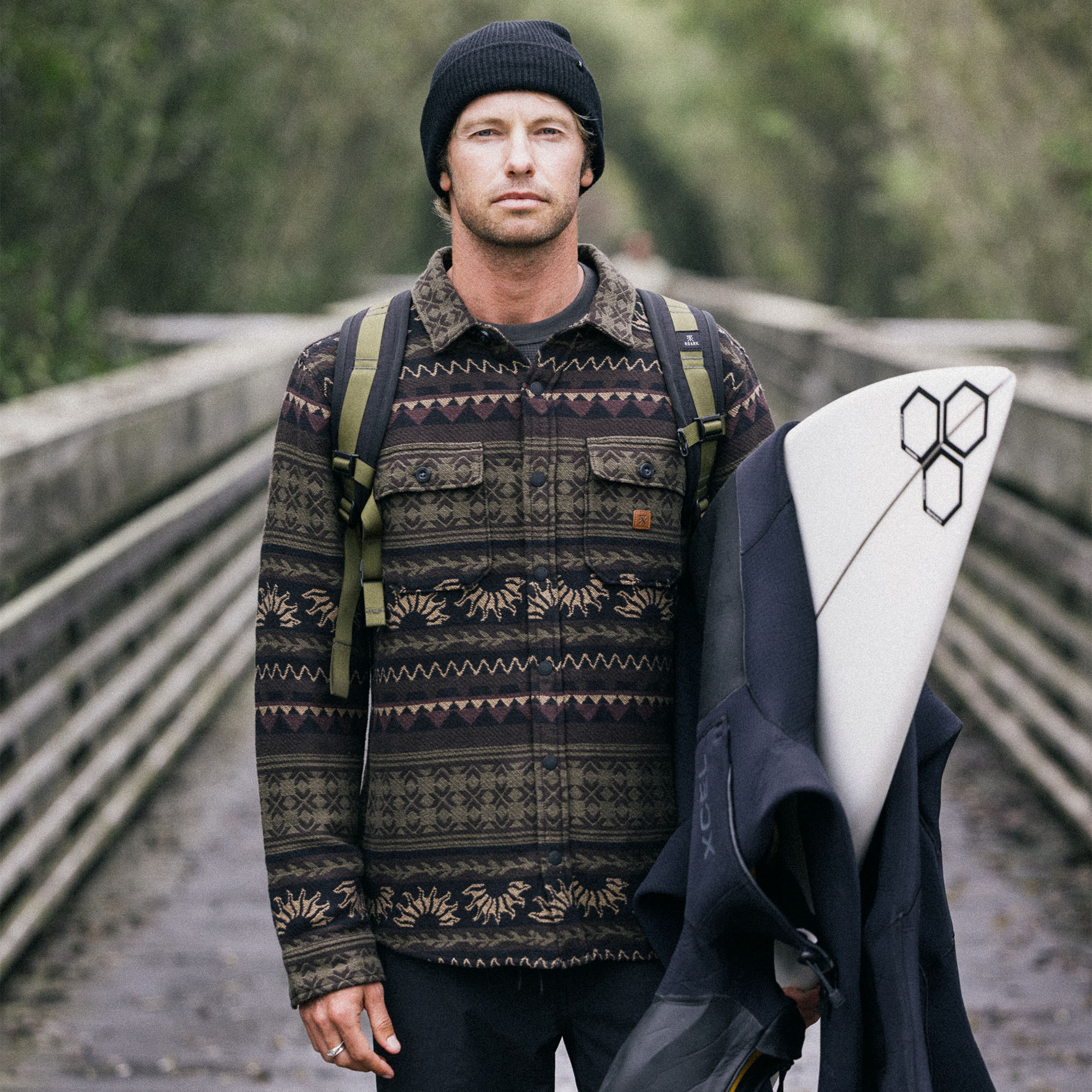 Man wearing Roark Nordsman Jacquard Long Sleeve Flannel, exploring scenic outdoor landscape while donning a beanie
