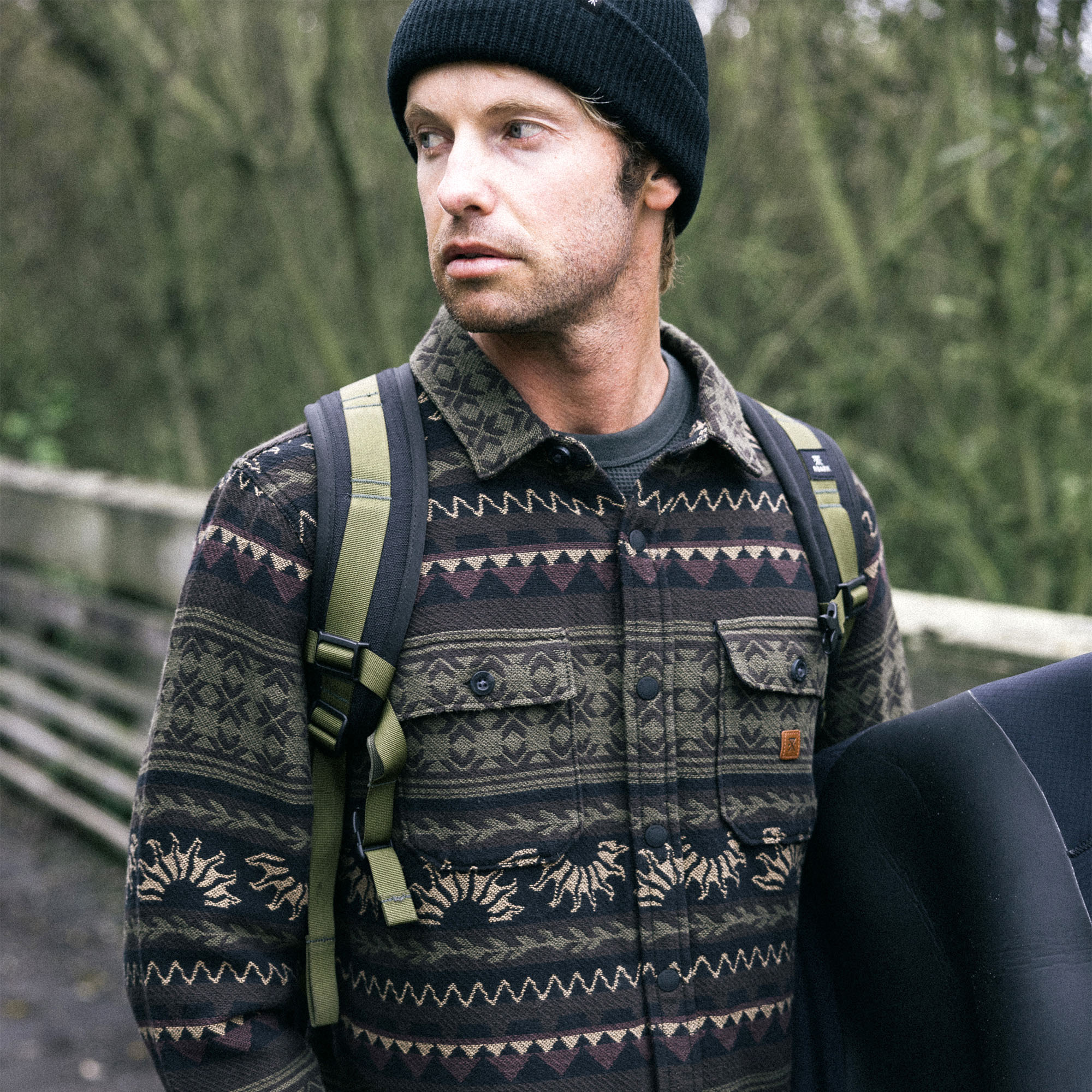 Model wearing a cozy knit cap styled with Roark's Nordsman Jacquard Long Sleeve Flannel, perfect for outdoor adventures and chilly travels.