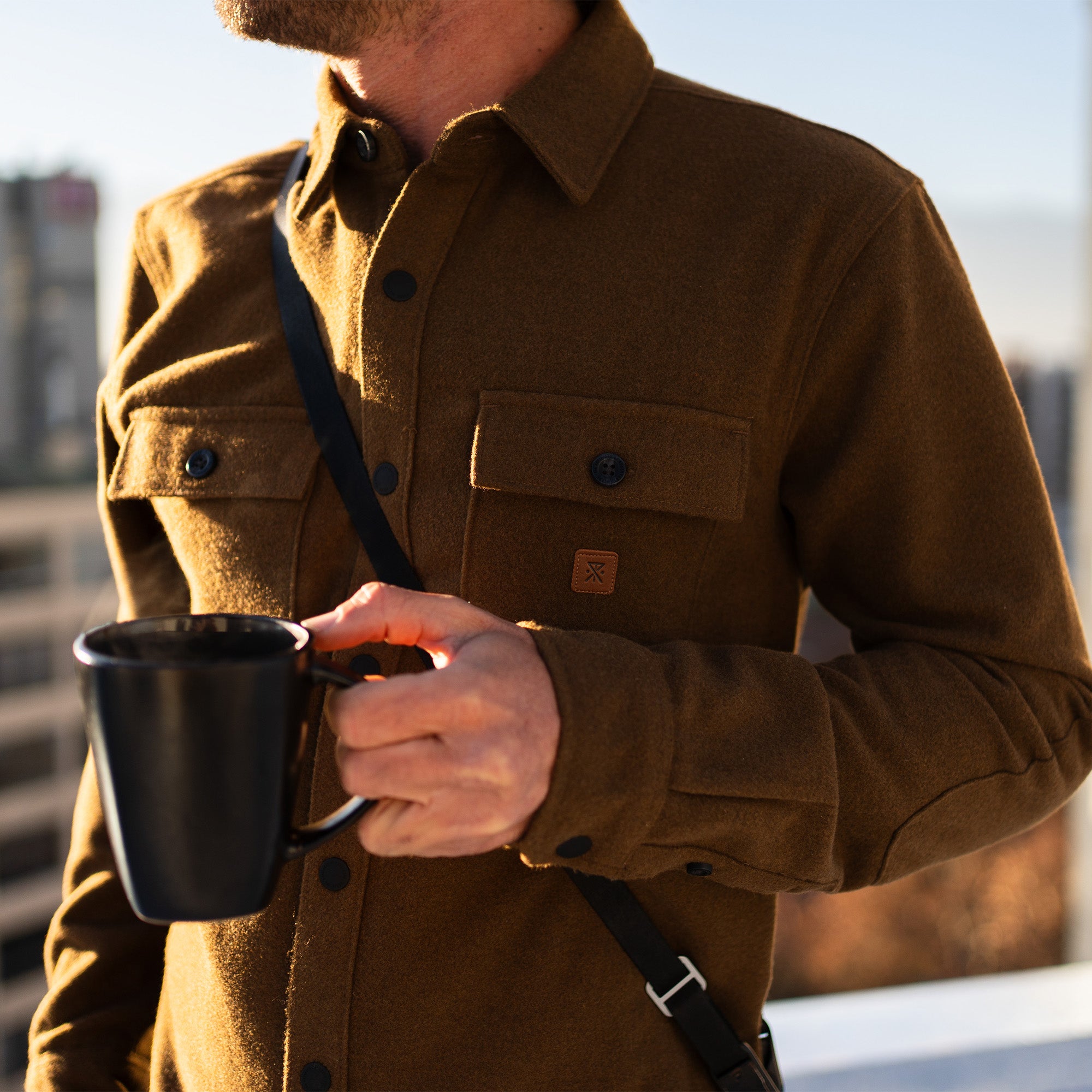 Man wearing Roark Nordsman Long Sleeve Flannel exploring a scenic forest during fall
