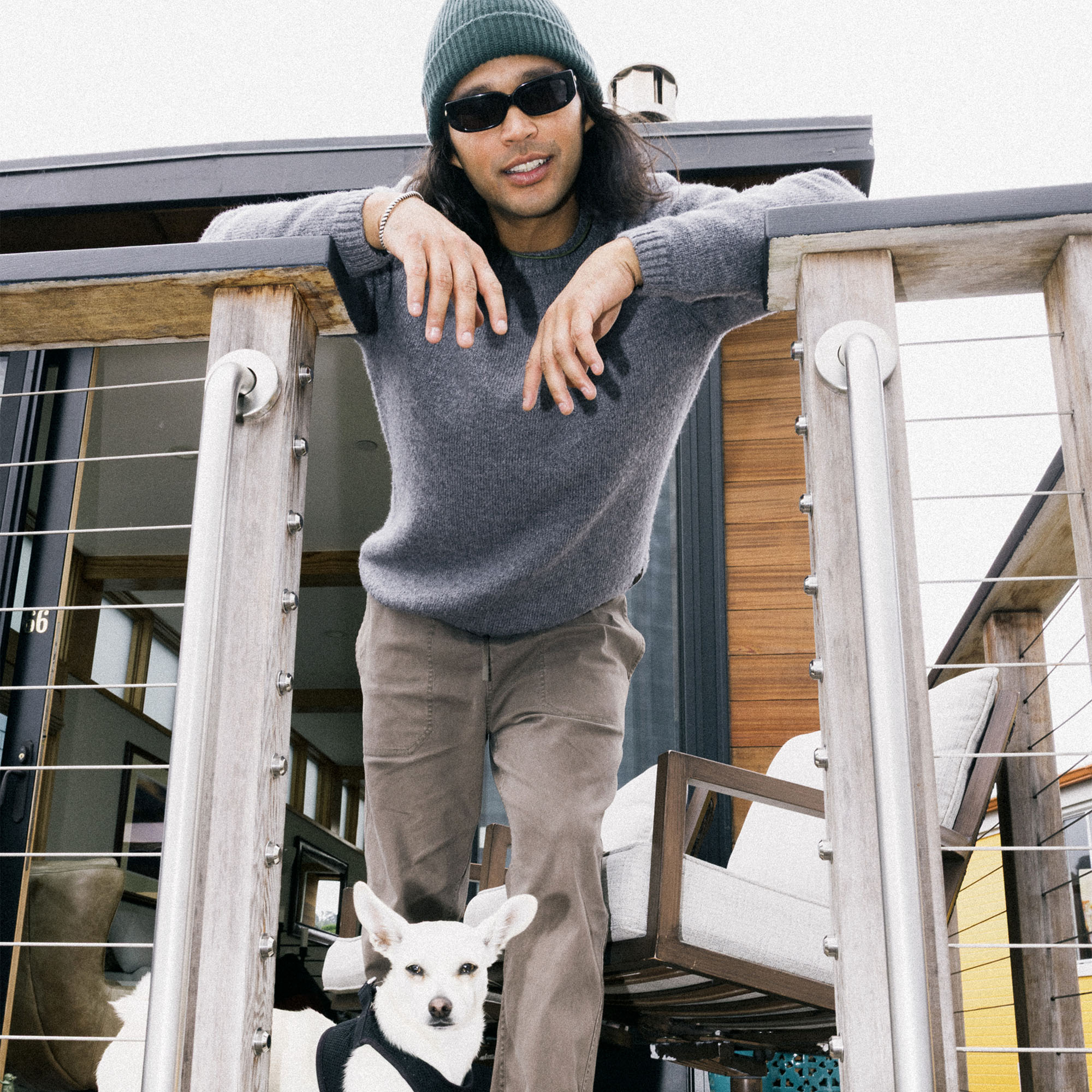 Adventure-ready scene with a dog and a person wearing sneakers, enjoying a leisurely outdoor moment, embodying the spirit of Roark’s travel and outdoor lifestyle.