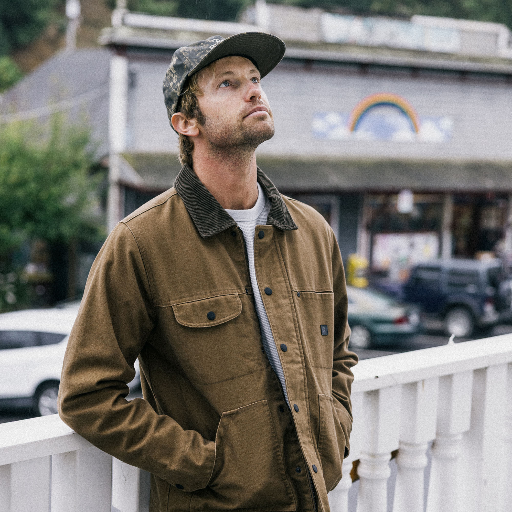 Man wearing Roark Open Roads Waxed Canvas Jacket in an adventurous outdoor setting, symbolizing rugged travel and exploration.