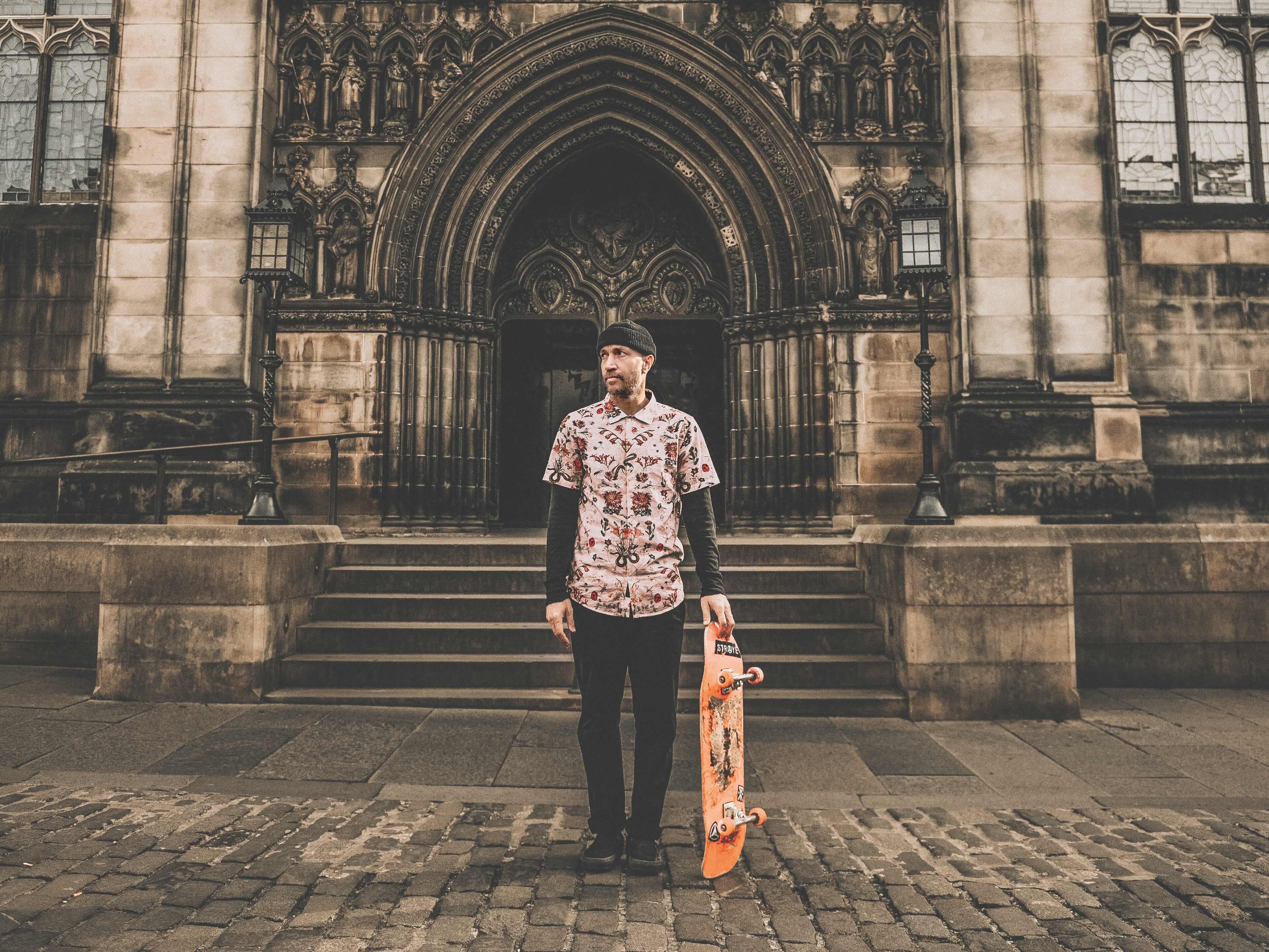 Skateboarder performing a trick in an urban setting with a stylish skateboard deck, capturing the essence of adventure and street culture.