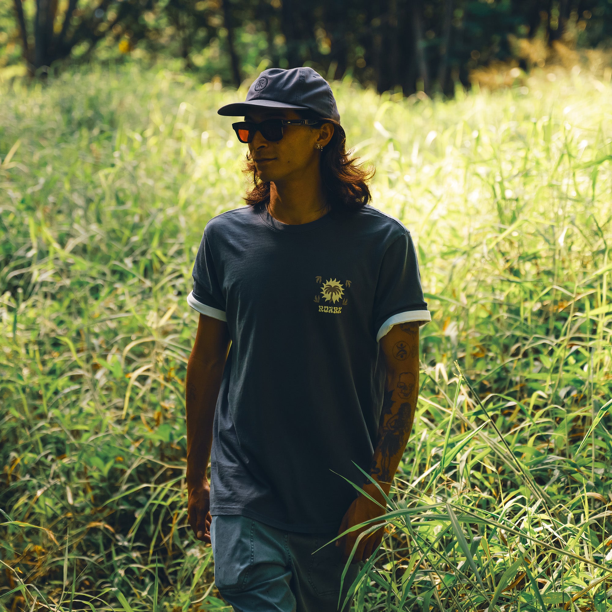 Active man wearing a Palm Premium Tee paired with a baseball cap, embodying Roark's adventure and outdoor travel lifestyle.