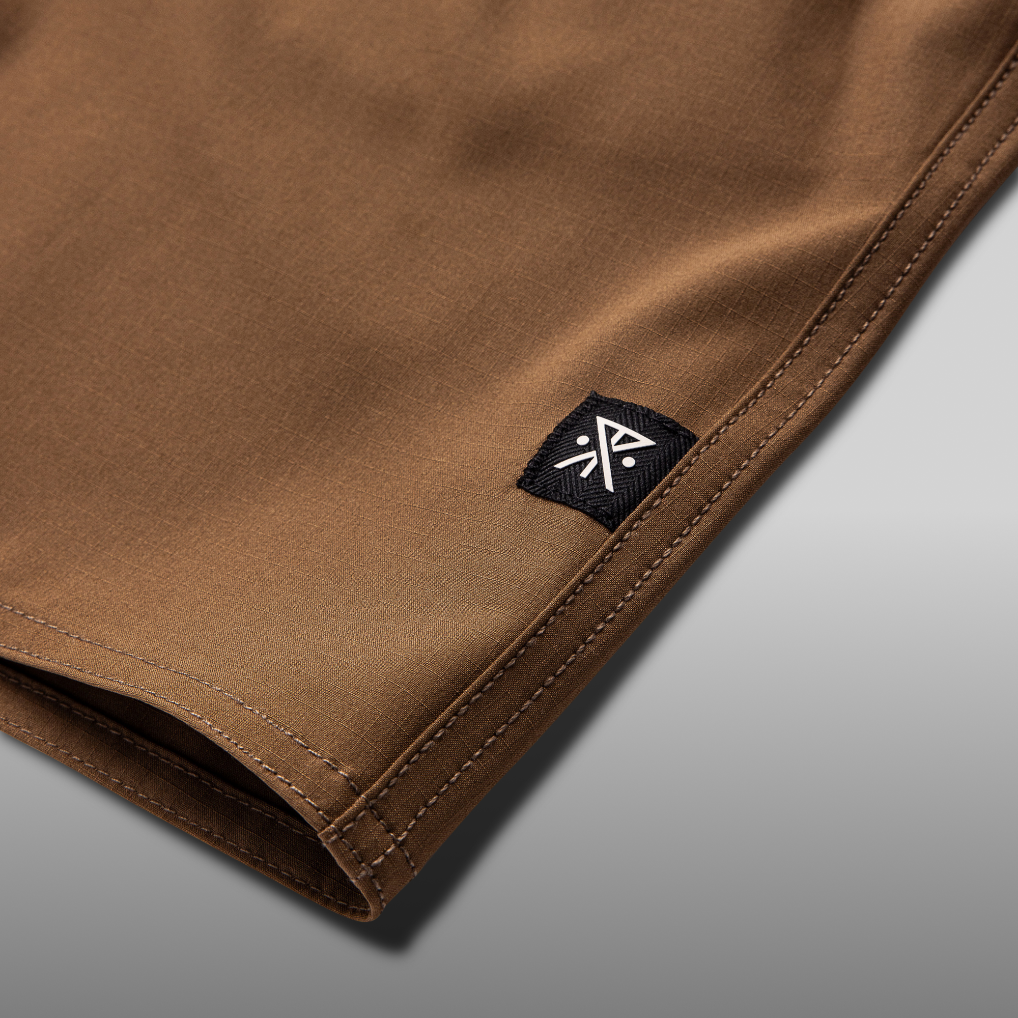 Close-up of a brown pocket detail on Roark adventure gear, highlighting durable material and practical design for outdoor activities.