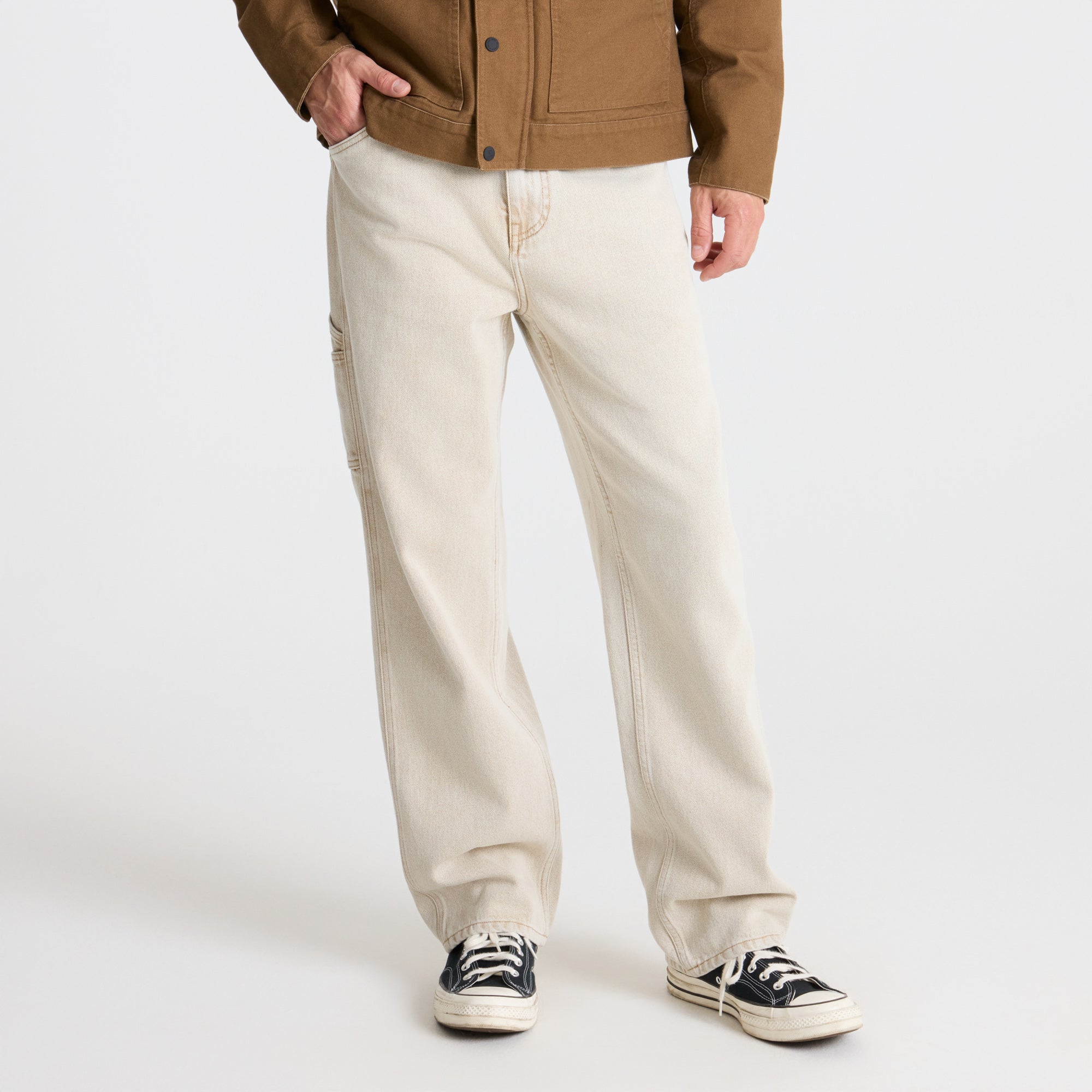 Detail of pockets and buttons on Roark adventure clothing, exemplifying durability and functionality for travel and outdoor activities.