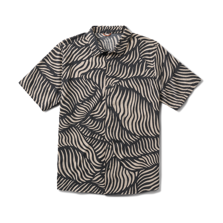 Close-up of a gray active shirt with visible sleeve, collar, and button details, displayed on a clothes hanger, designed for adventure and travel.