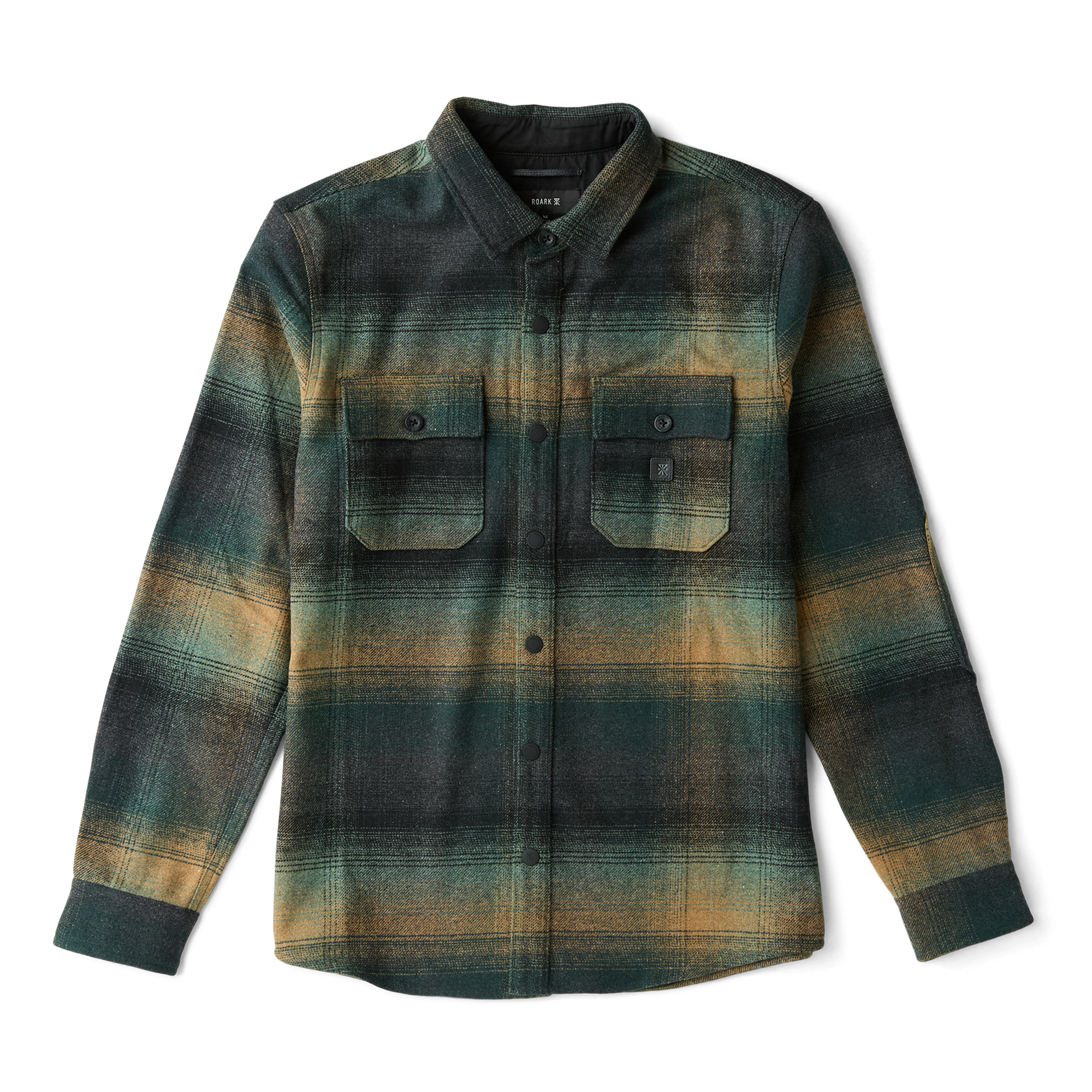 Roark adventurer wearing outdoor apparel in a scenic setting, embodying the spirit of exploration and travel.