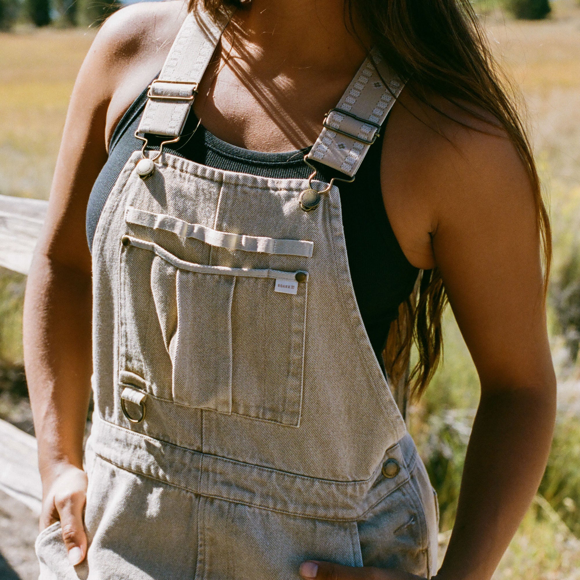 Roark man wearing a t-shirt and shorts in a sunny outdoor setting, showcasing Roark's Leave-Behind lifestyle collection