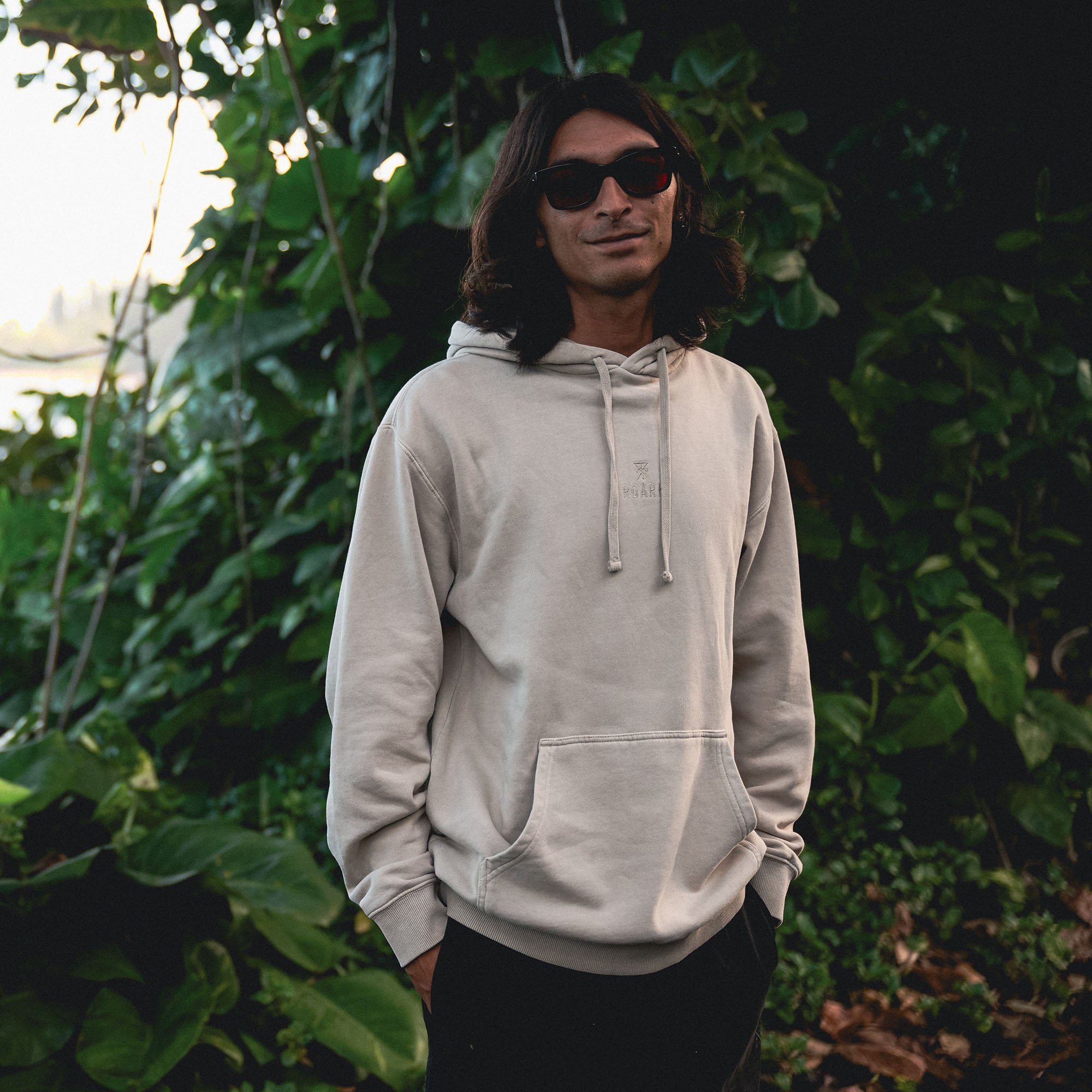 Close-up of a Roark Safe Camp Embroidery Fleece showing detailed embroidery on the sleeve and hood, perfect for outdoor adventures and cozy camp evenings.