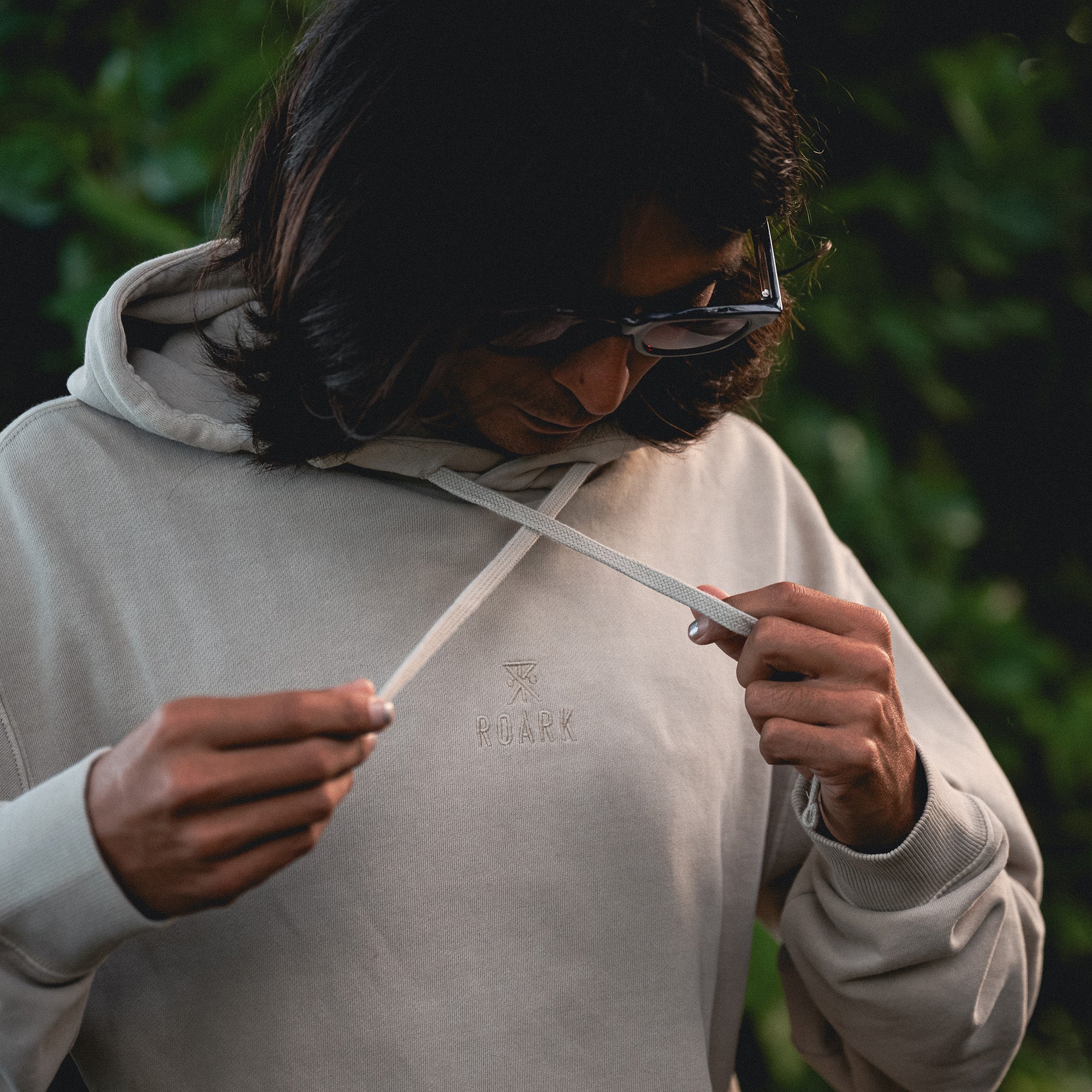 Close-up of Roark's Safe Camp Embroidery Fleece with detailed sleeve and hood design, perfect for outdoor adventures.