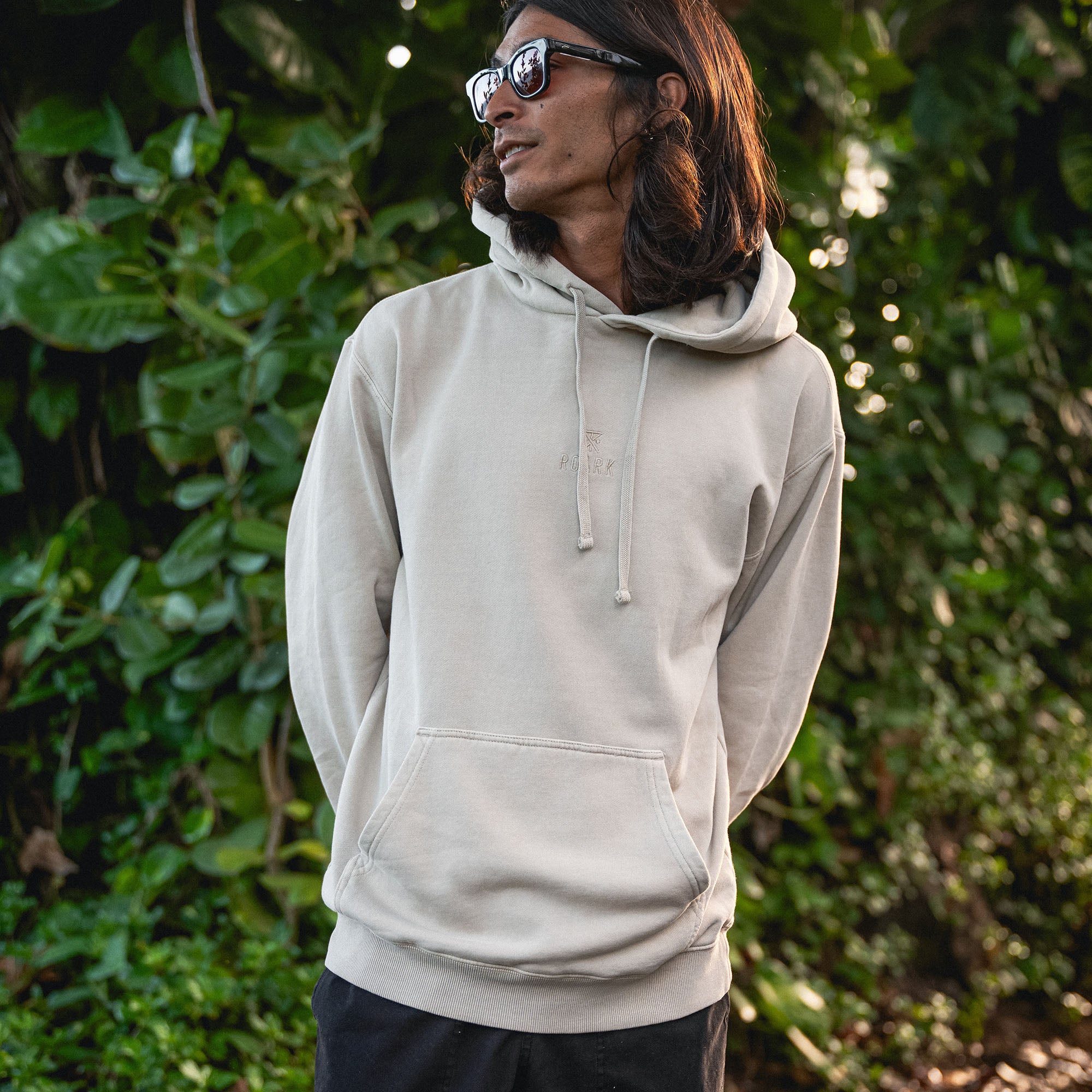 Close-up of the Safe Camp Embroidery Fleece from Roark, featuring detailed stitching on the sleeve and hood designed for outdoor adventures.