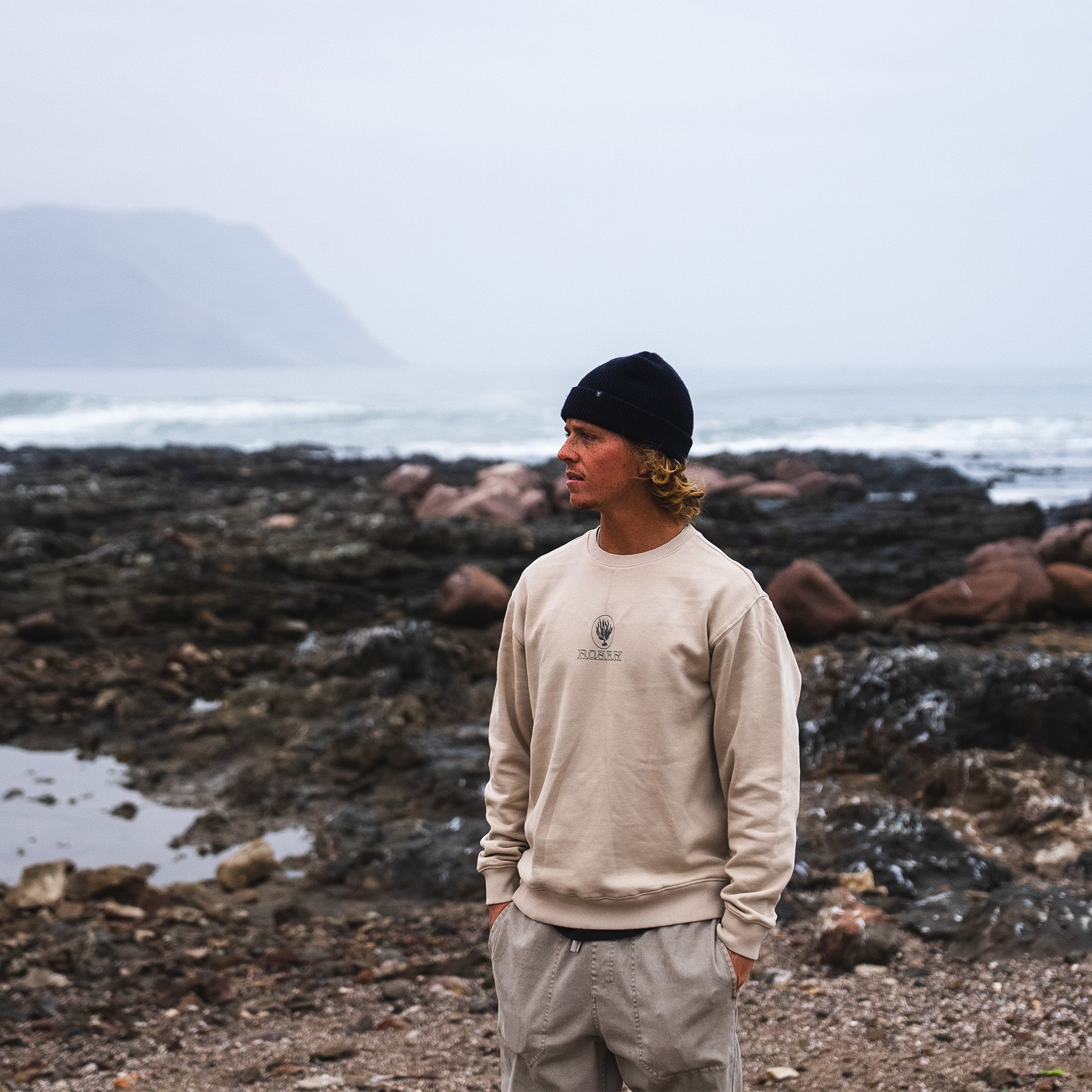 Close-up of a Roark Seaweed Knowledge Fleece Tee with long sleeves and cap hood, perfect for outdoor adventures and travel in cooler weather.