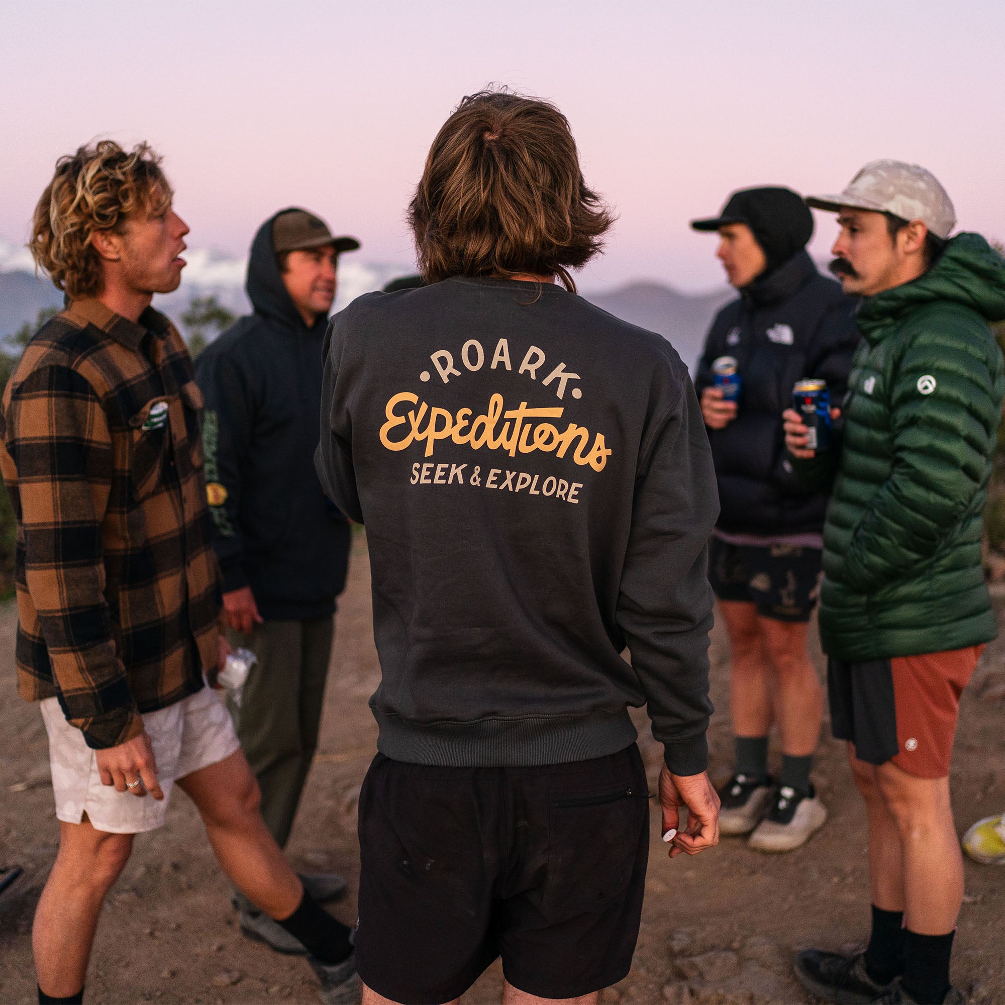 Person wearing a Roark Sign Writer Fleece Hoodie, exploring a snowy landscape, highlighting the hoodie's functionality and comfort in winter outdoor settings.