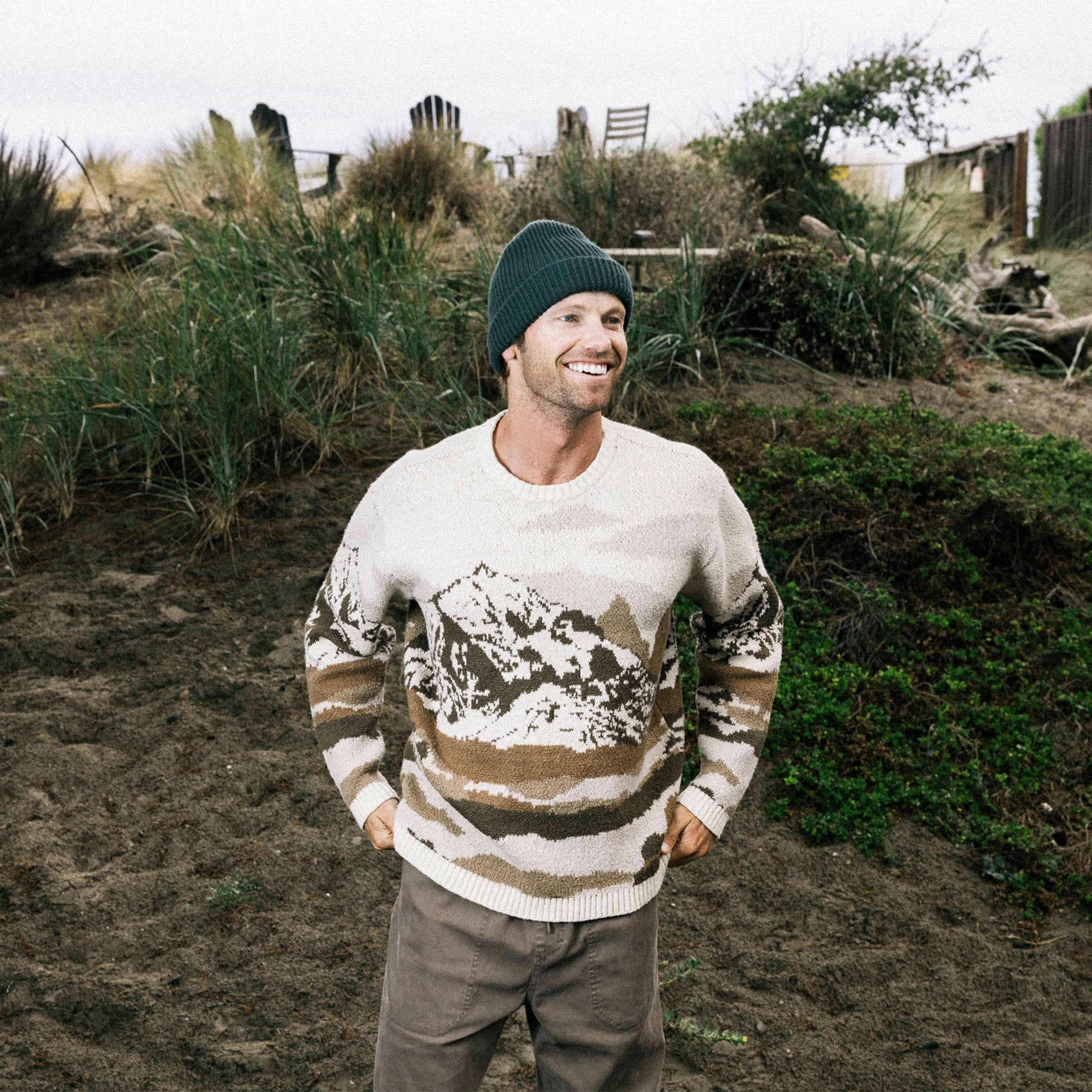 Bearded man wearing a Roark Tierra del Sur long sleeve wool sweater in a snowy winter setting, embodying adventure and the great outdoors.