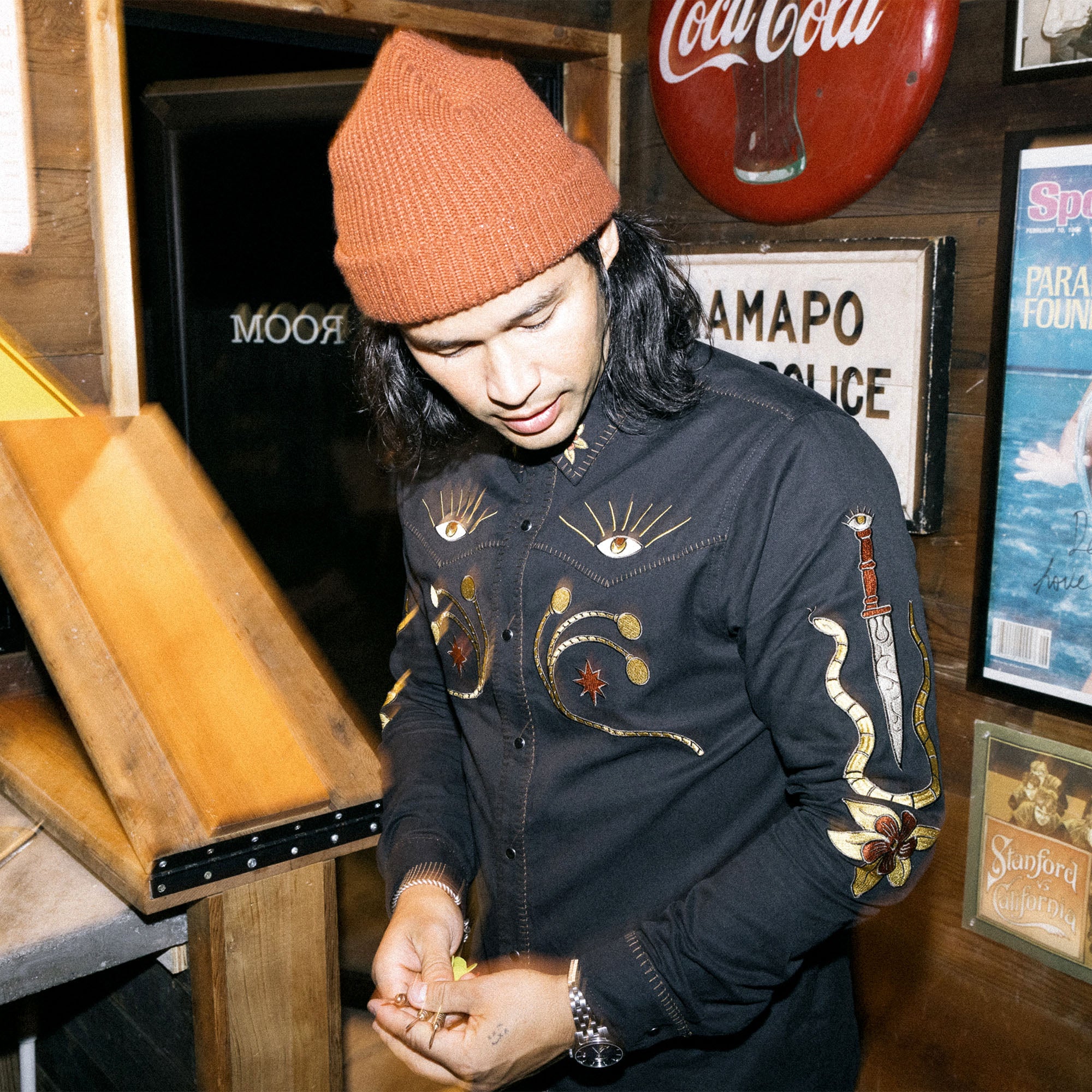 Model wearing Roark's Tierra del Sur Range Long Sleeve Button-Up, styled with rugged denim, perfect for adventure and outdoor travel.