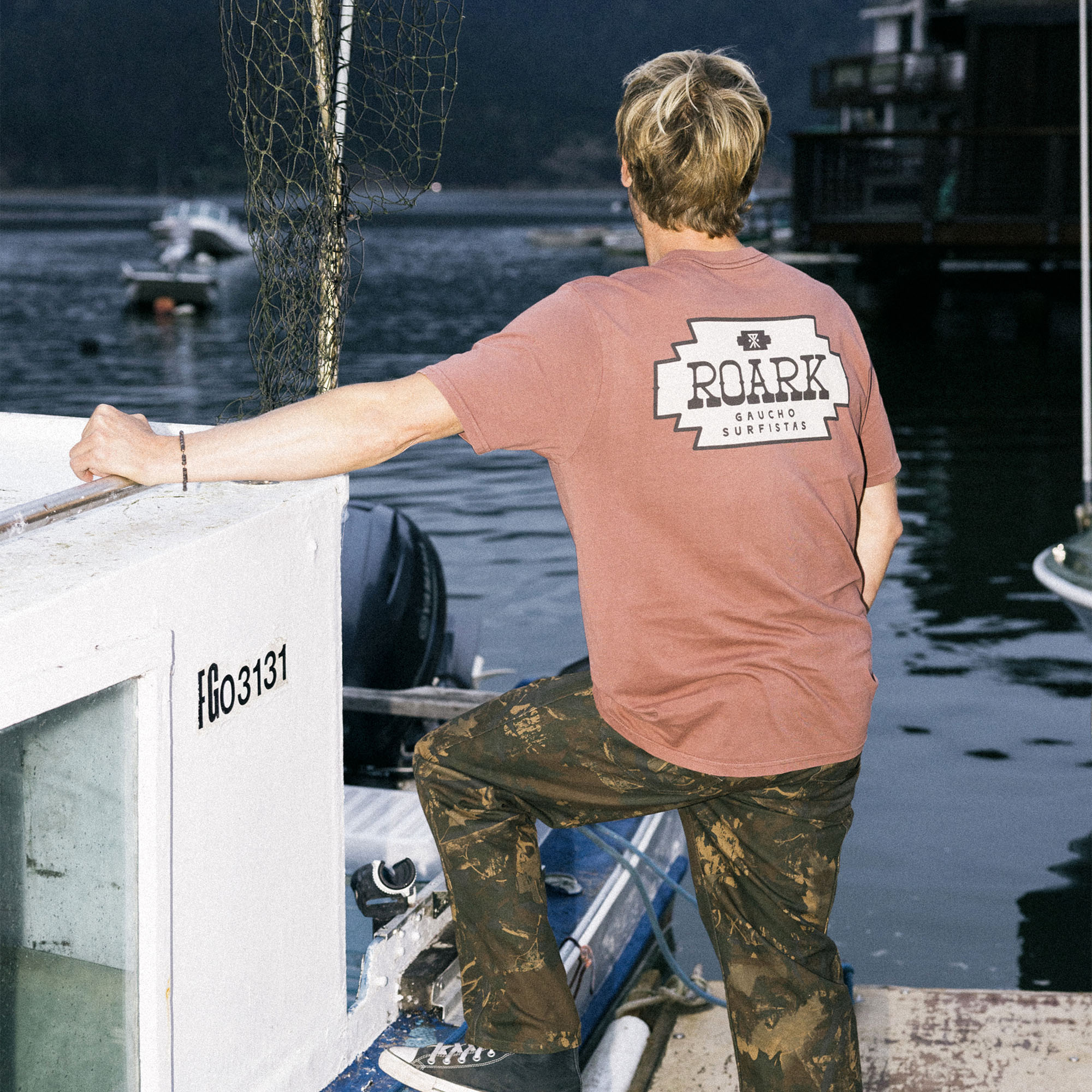 Stylish Bermuda shorts paired with an active shirt and sunglasses, embodying Roark's adventure-ready apparel