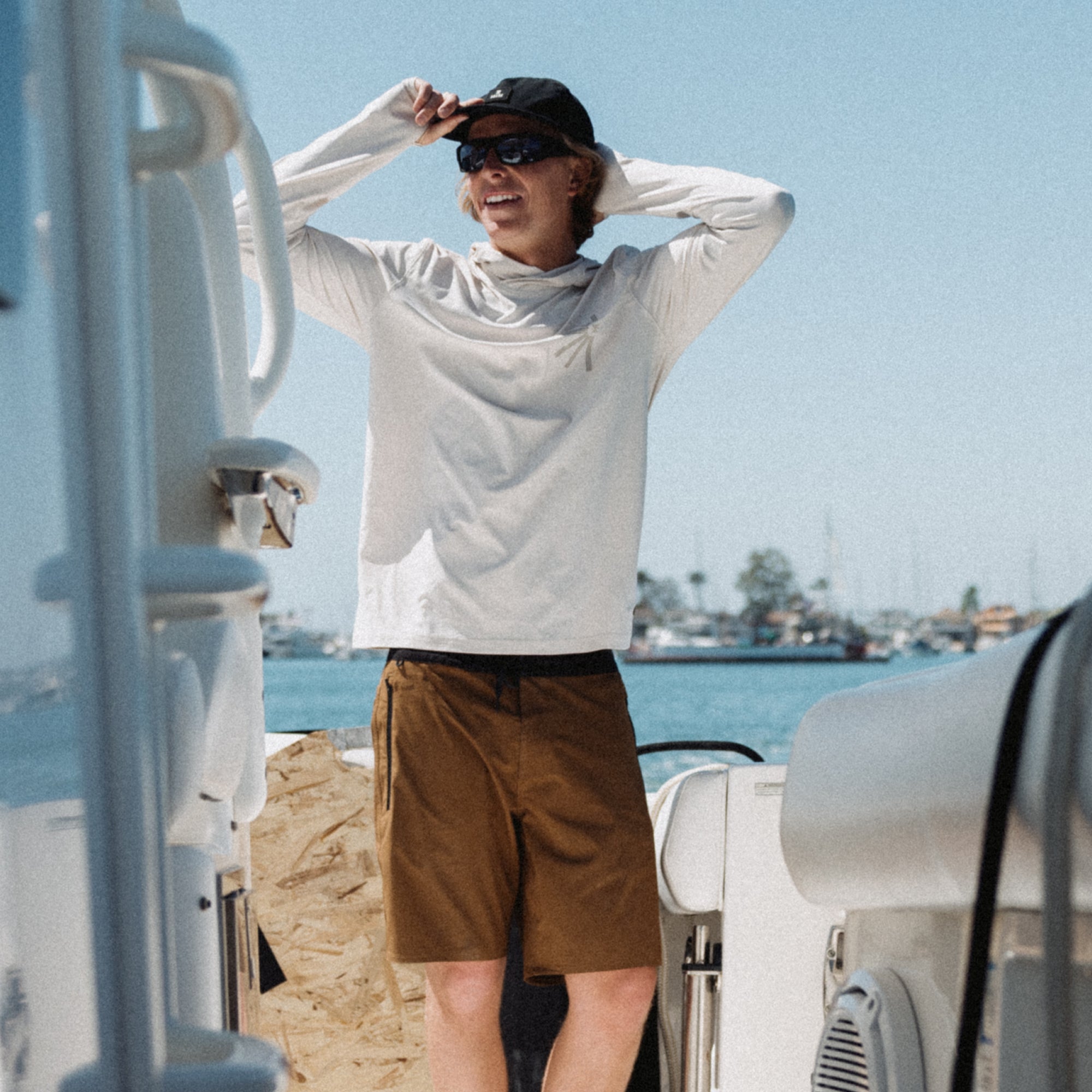 Stylish boardshorts and hat set against a summer backdrop, perfect for outdoor adventures and travel.