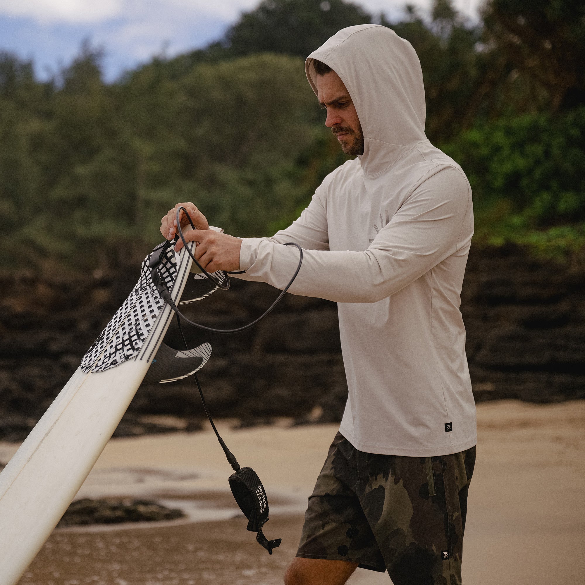 Group of people wearing Roark Venture UPF Hoodies enjoying a beach scene, symbolizing adventure and outdoor lifestyle.