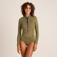 Woman in an olive green long sleeve swim one-piece with a front zipper, perfect for surfing and watersports, showcasing style and functionality.
