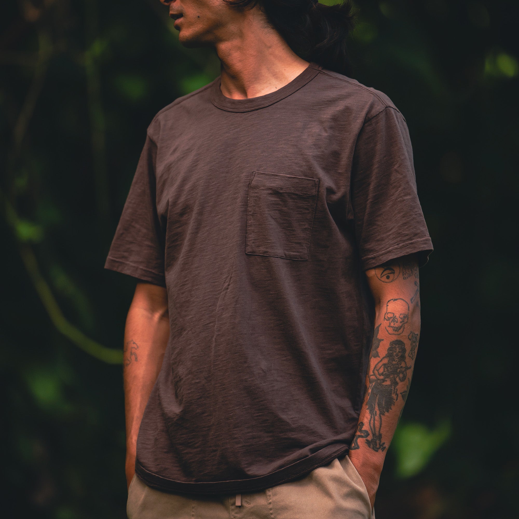 Close-up view of a Roark Well Worn Organic Short Sleeve Tee, highlighting its sleeve, neck design, and chest pocket, ideal for active outdoor adventures.