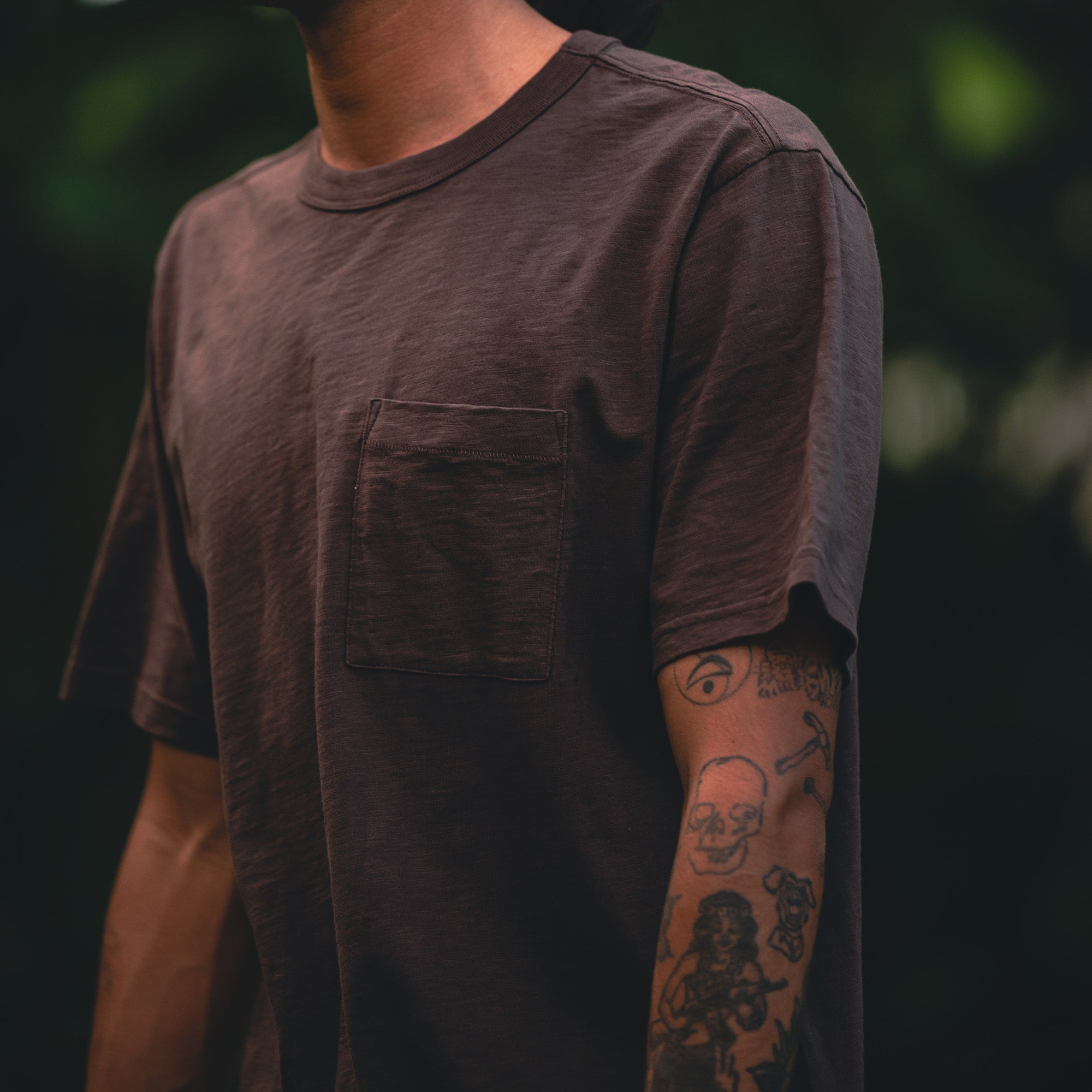 Close-up of a Roark Well Worn Organic Short Sleeve Tee highlighting the comfortable fit across the shoulders, neckline, sleeves, and waist, perfect for outdoor and travel adventures.