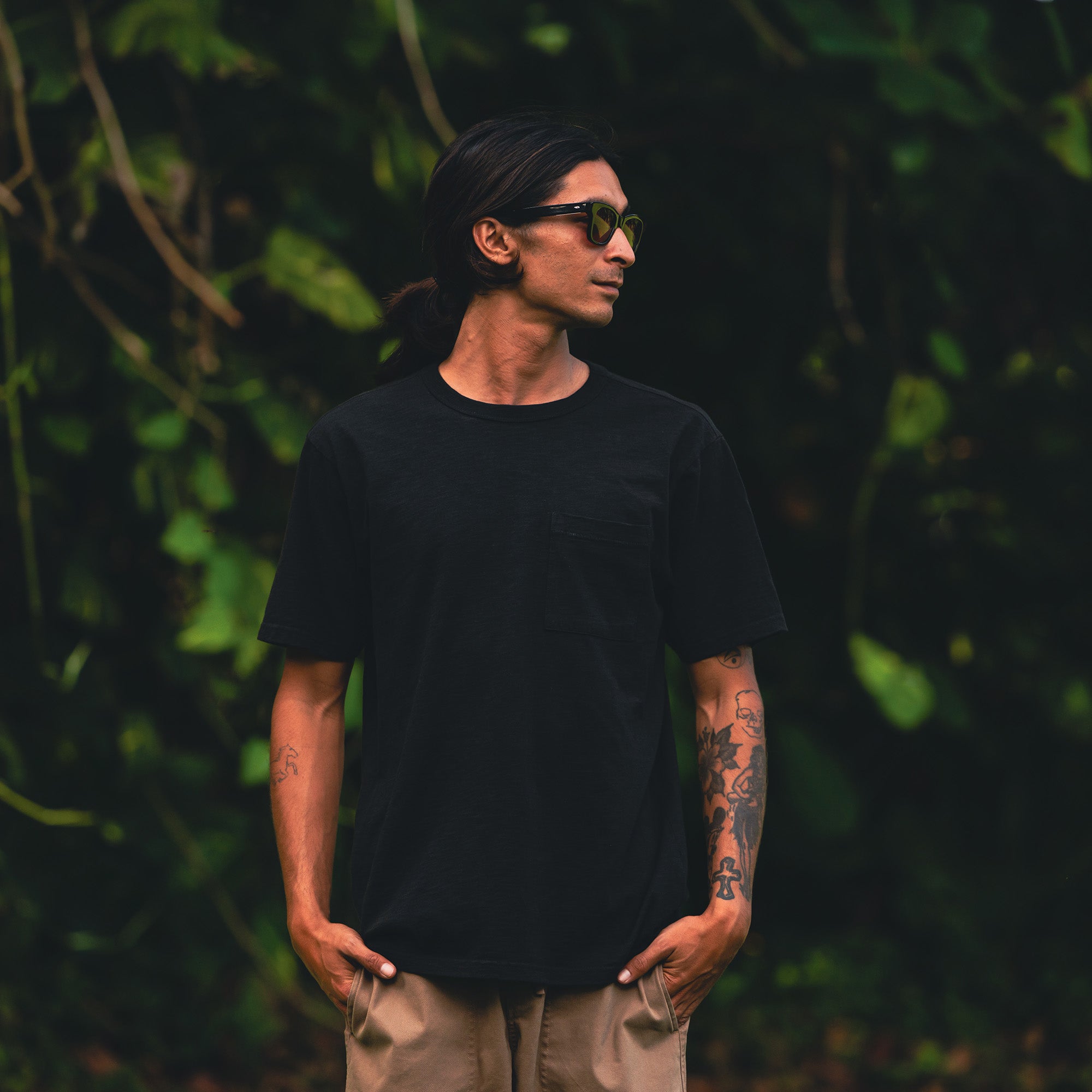 Man adventuring outdoors wearing Roark’s Well Worn Organic Short Sleeve Tee, complemented with stylish eyewear.