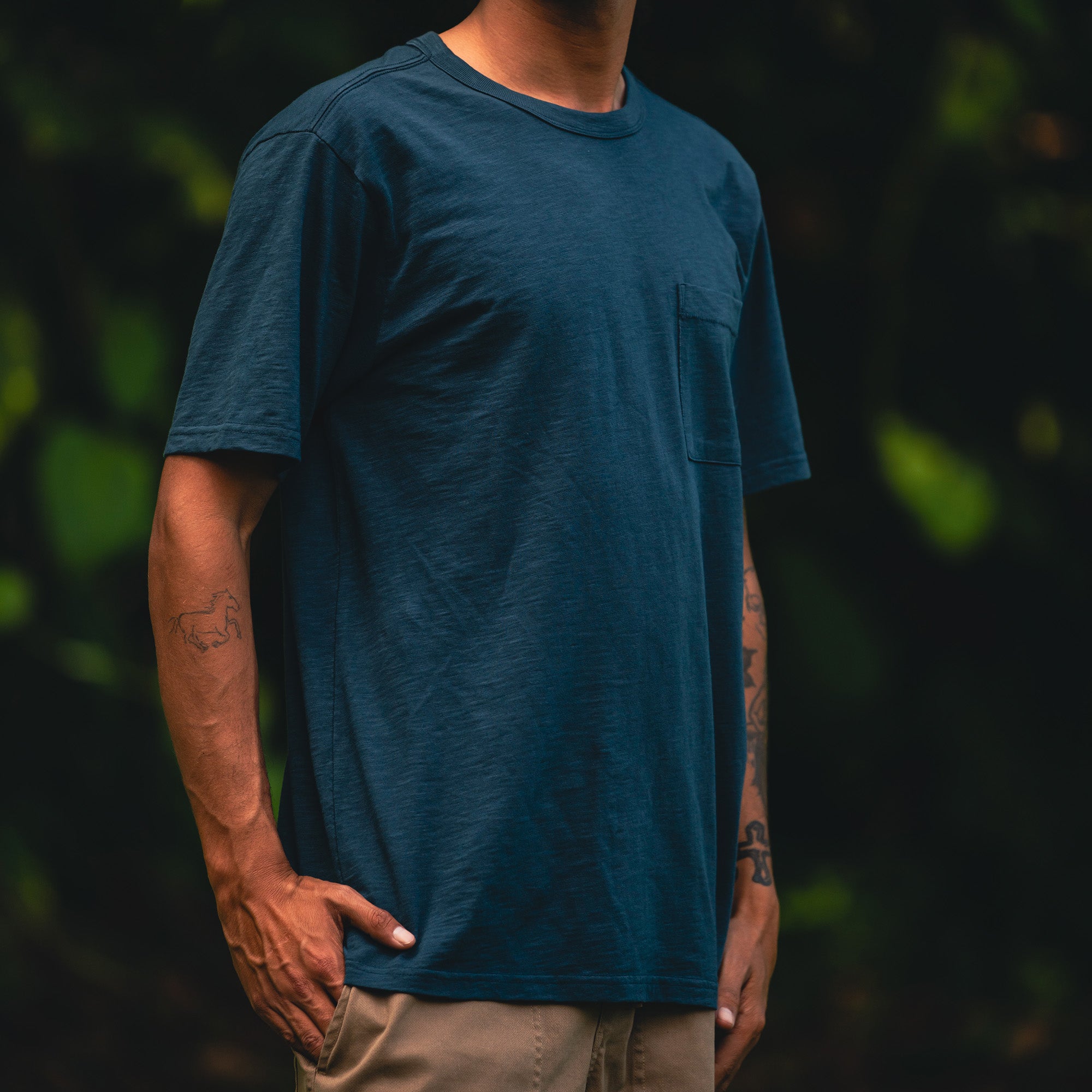 Person wearing Roark's Well Worn Organic Short Sleeve Tee while exploring nature, embodying the spirit of adventure and sustainable outdoor apparel.