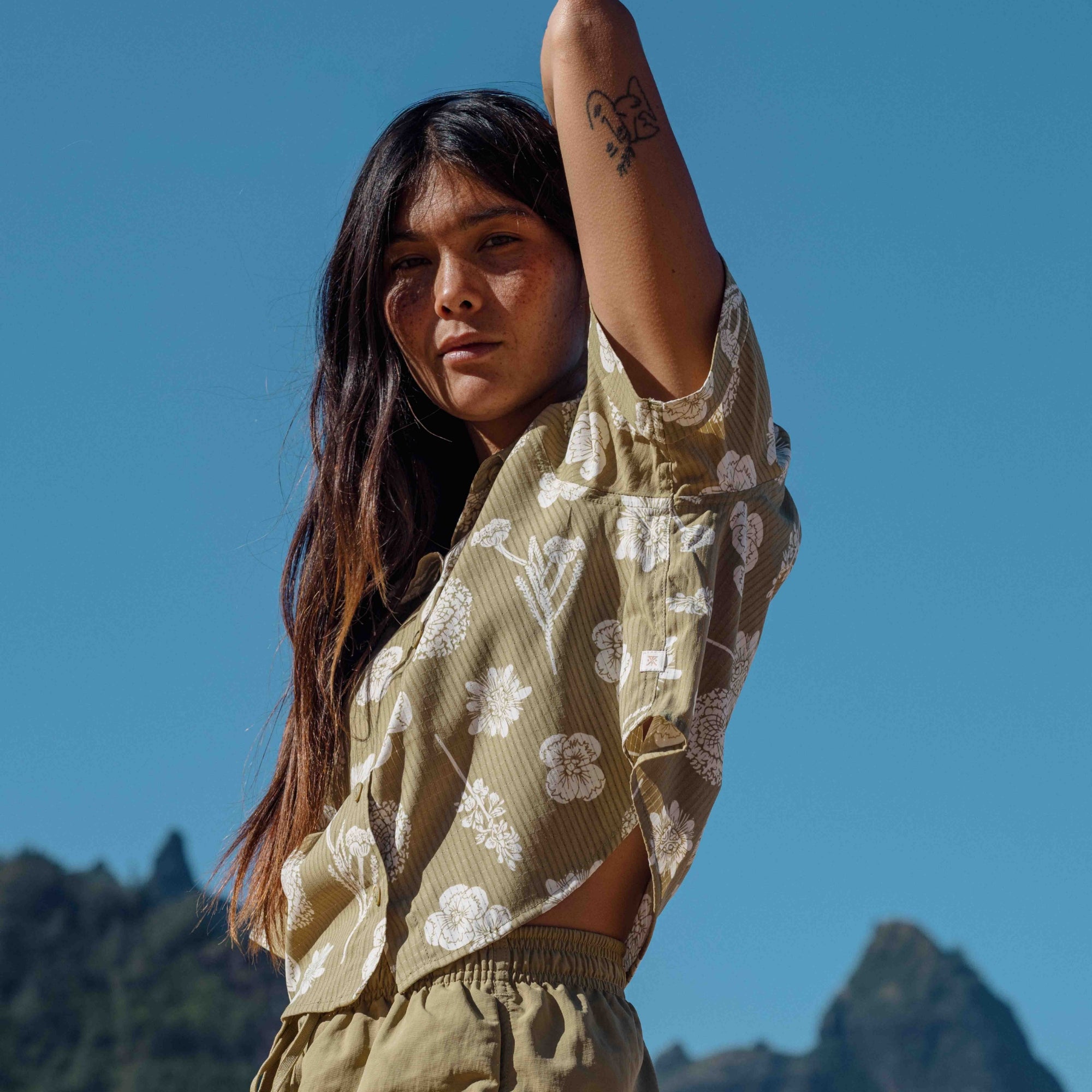 Adventure-ready Roark women's Bless Up shirt modeled outdoors, emphasizing a relaxed yet stylish fit perfect for travel and exploration.