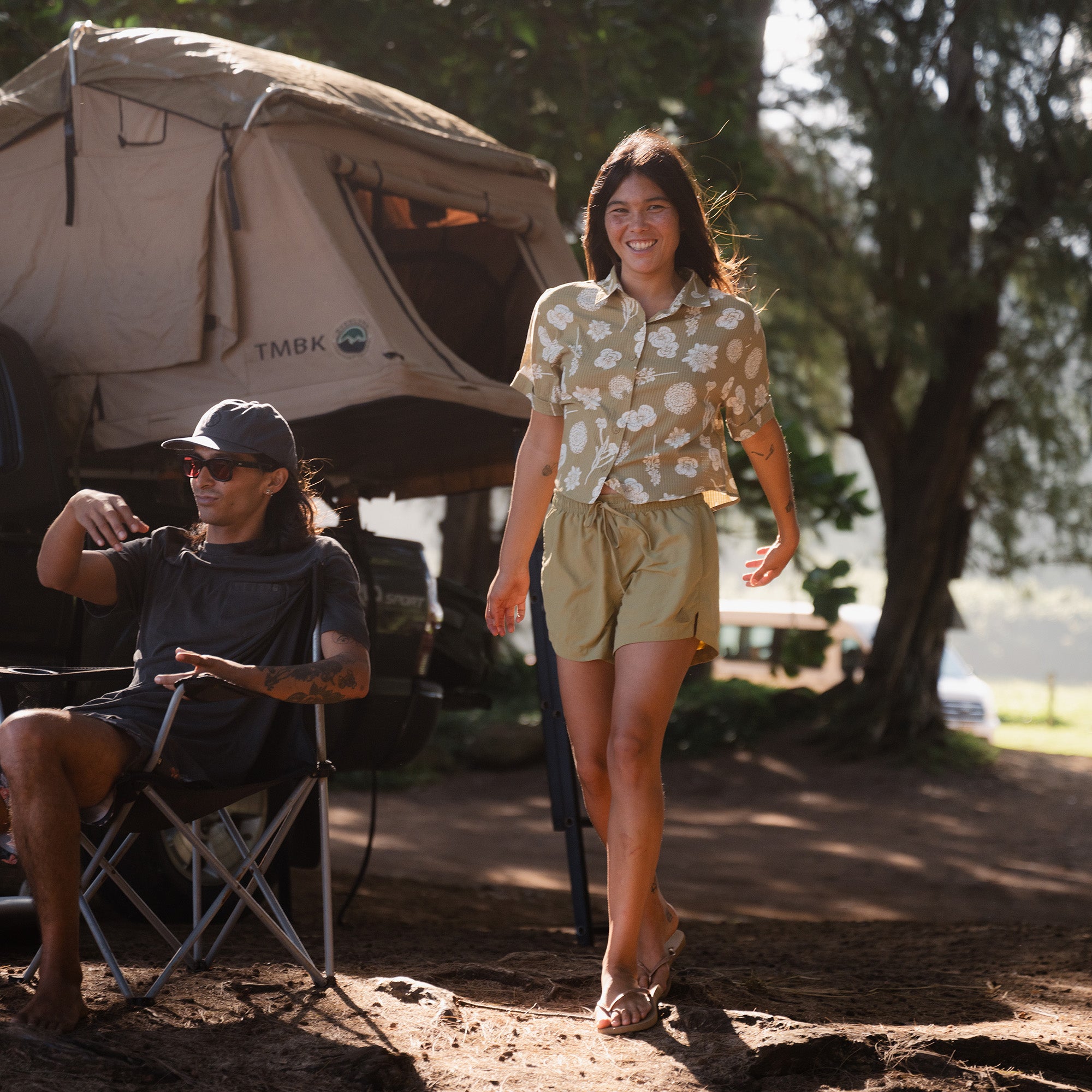 Adventure-ready woman with sun hat and bag enjoying leisure time in a tropical setting, embodying the spirit of Roark's outdoor lifestyle
