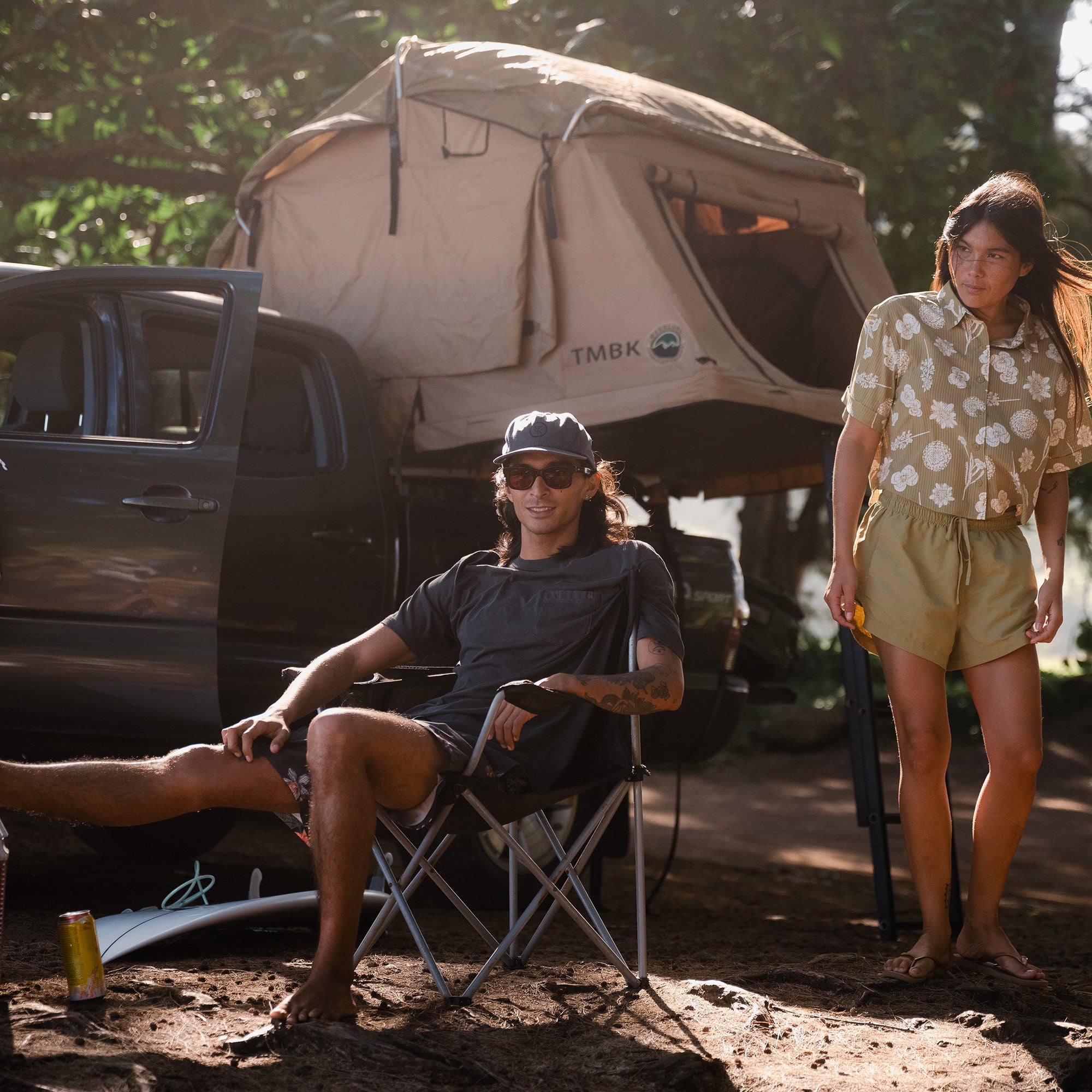 Group of friends enjoying a camping trip with a tent in a scenic outdoor setting, embodying the spirit of adventure and travel.