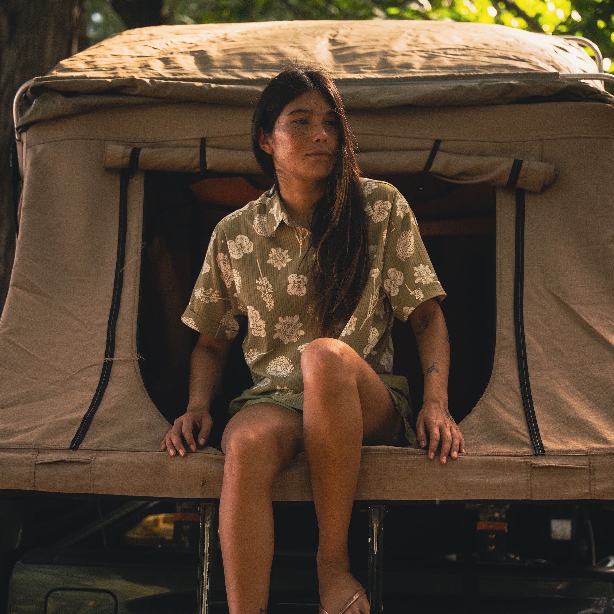 Adventure scene with a car door open beside a tent, encapsulating the spirit of camping and travel